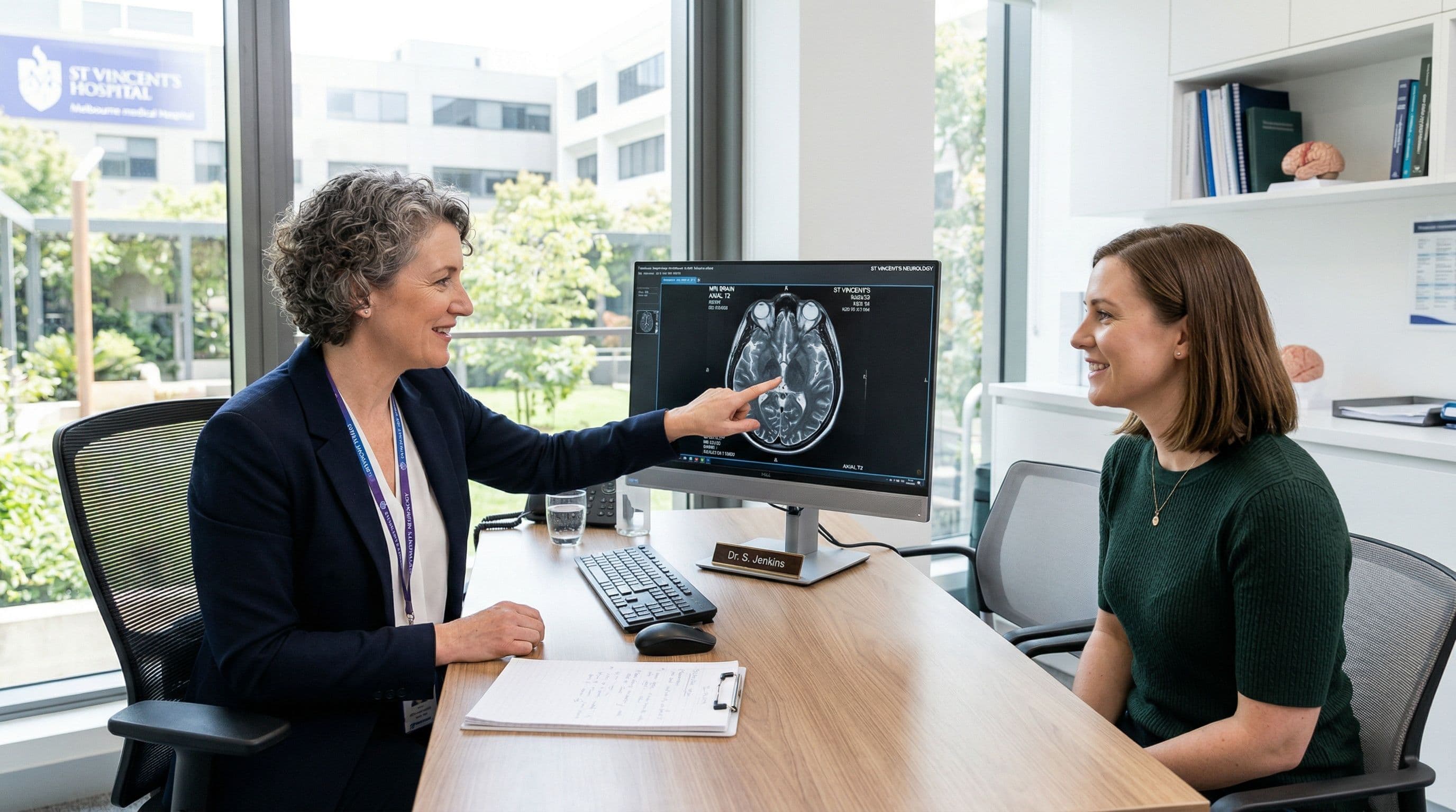 A neurologist discussing MRI results with a patient during a multiple sclerosis consultation.