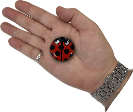 A palm with a HeartBug monitoring device being held.