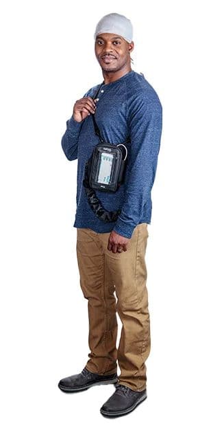 A dark-skinned man wearing an ambulatory EEG setup, wearing a white scarf and a Trex HD ambulatory EEG device.